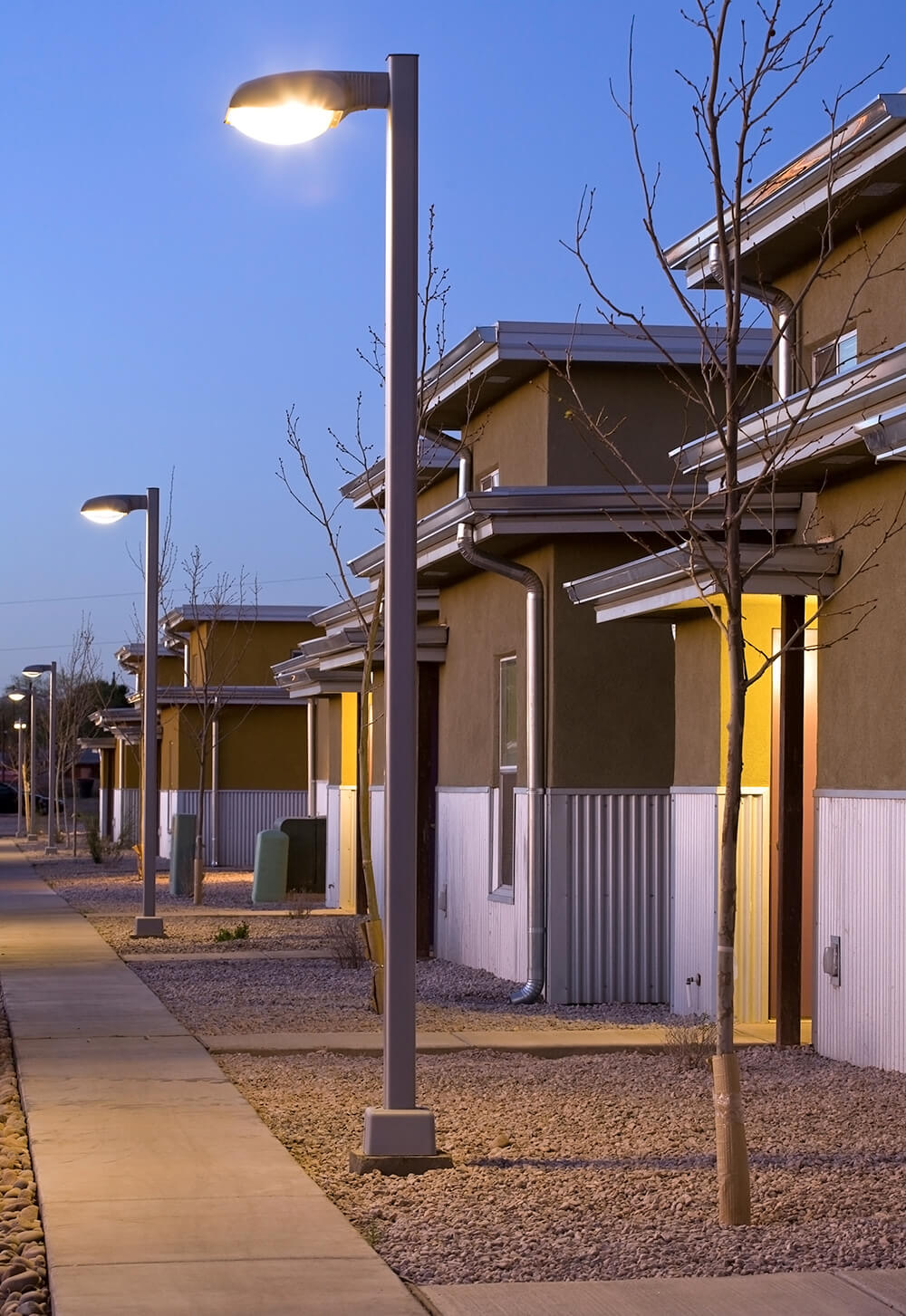 Lighted walkway between apartment homes at Cottonwood Commons in the evening, Alamogordo NM