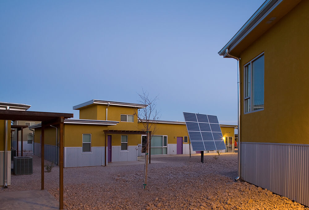 Courtyard at Cottonwood Commons at dusk with the community solar array between the homes