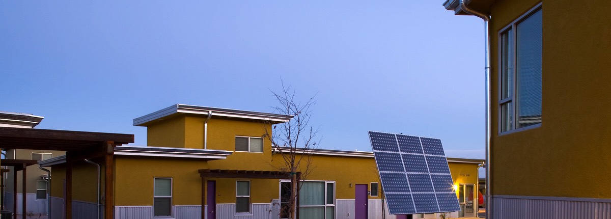 Evening view across the Cottonwood Commons courtyard in Alamogordo with the community solar array at dusk